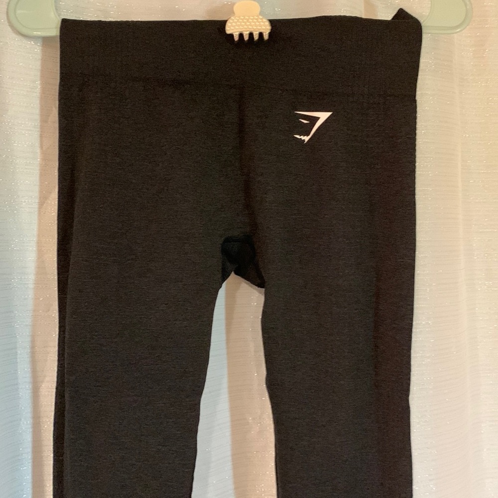 black sport leggings. Ribbed material texture near bottom of legs